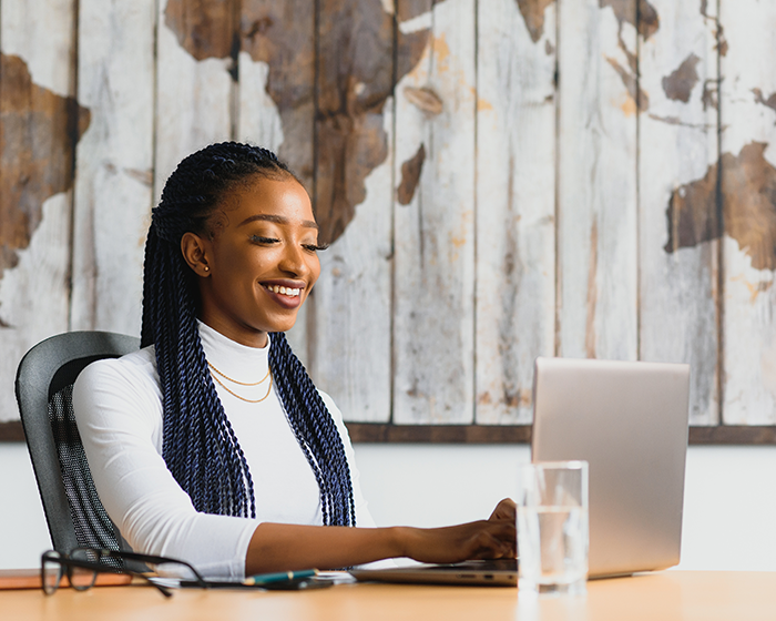 Woman dressed smart working on laptop