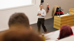 Man standing in front of an audience.