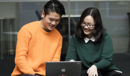 Students sitting together at a laptop