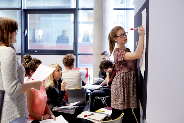 A student writing on a board