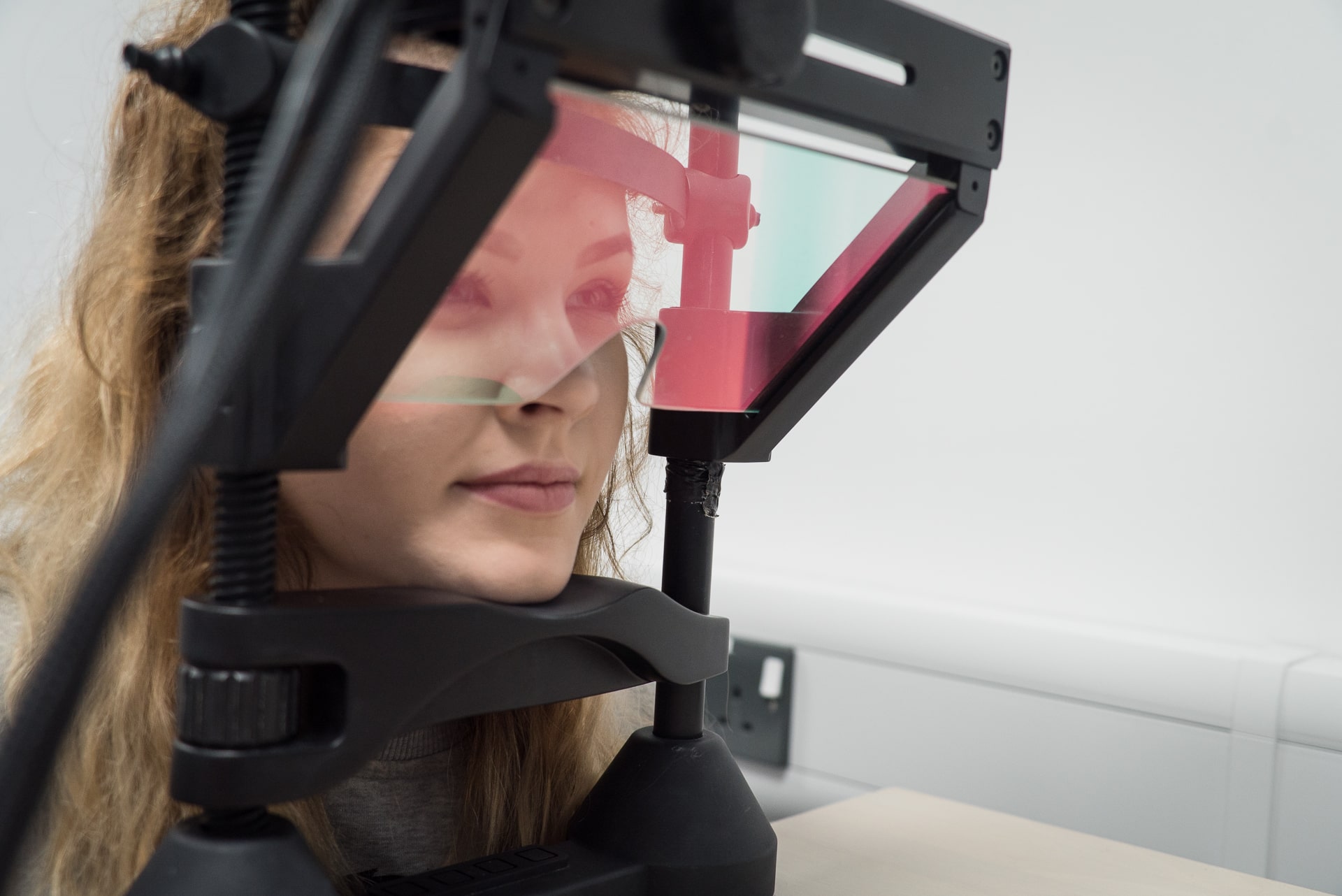 Woman engaging with psychological testing equipment.