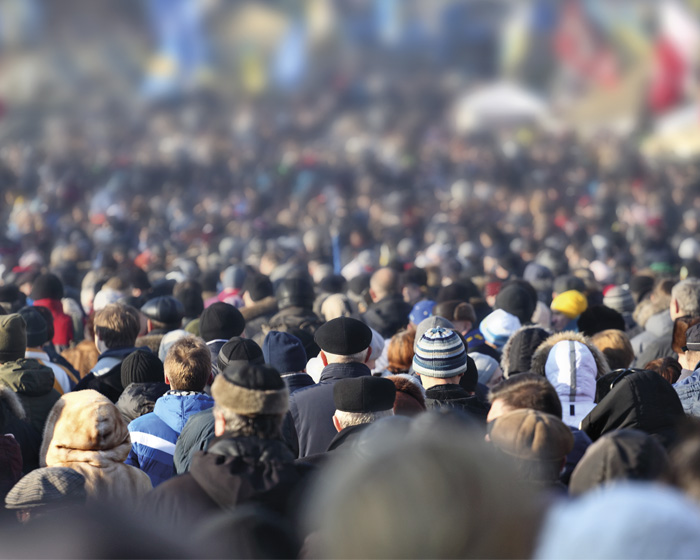 A crowd of people walking down a street