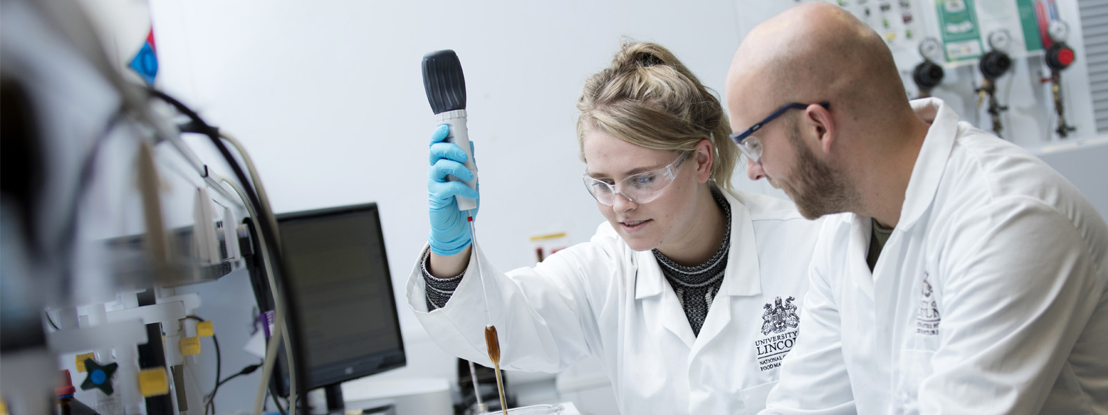 Female student alongside an academic working in a laboratory 