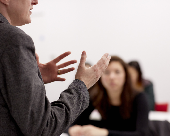 A lecturer talking to a class of students