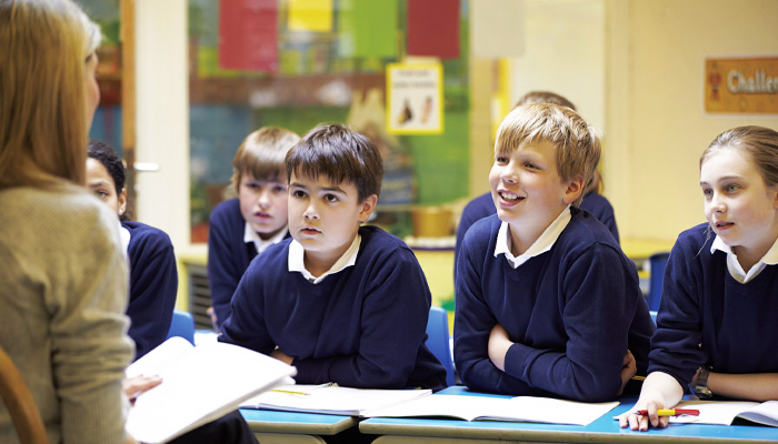 A teacher talking to pupils in a classroom