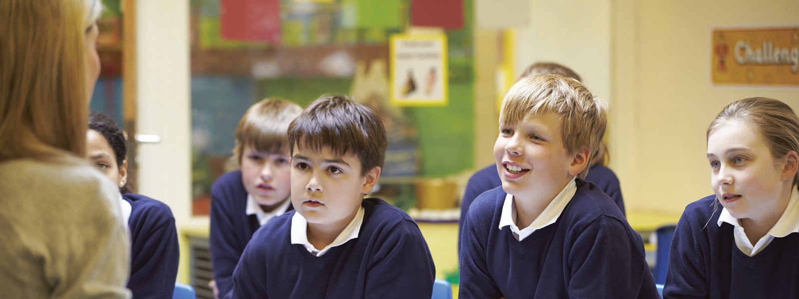 A teacher talking to pupils in a classroom