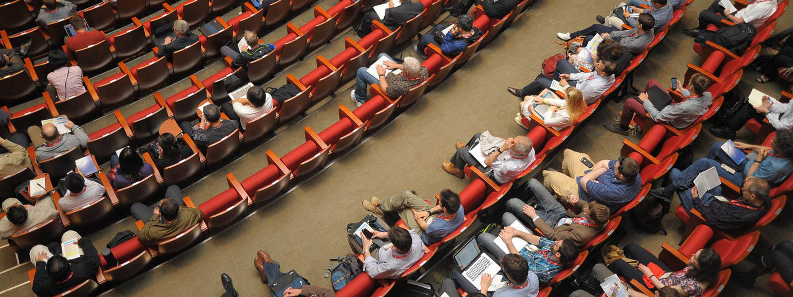 Attendees sitting in chairs at a conference