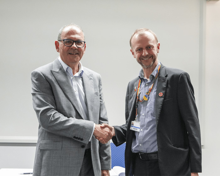 University of Lincoln and University of Hull vice chancellors shake hands