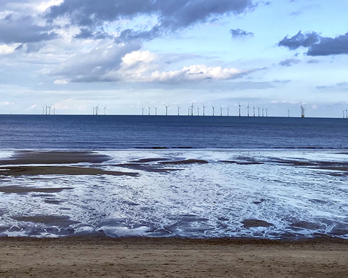 Coastline with wind turbines out at sea