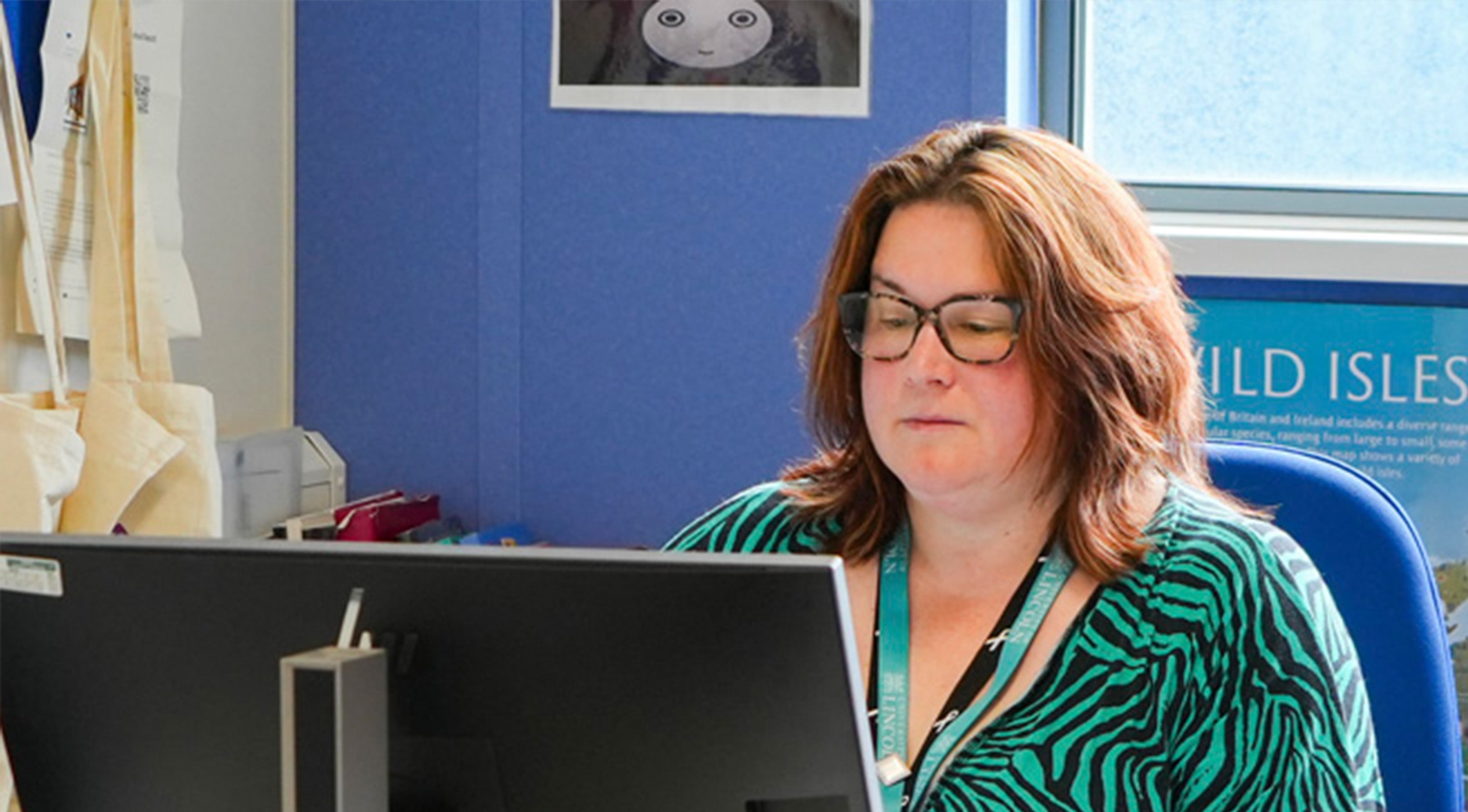 Photo of Nicki Pierce at a computer