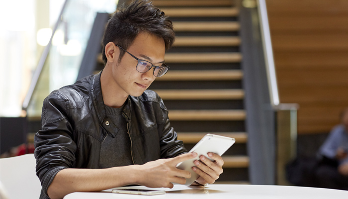 A male student on a mobile smartphone