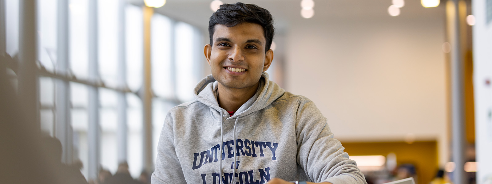A student in a University of Lincoln jumper