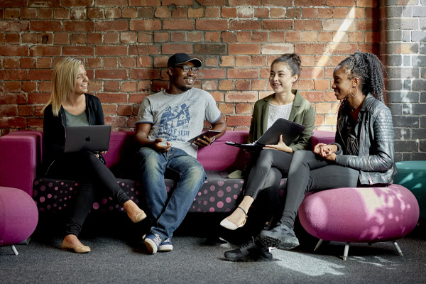 A group of students sat chatting in the library