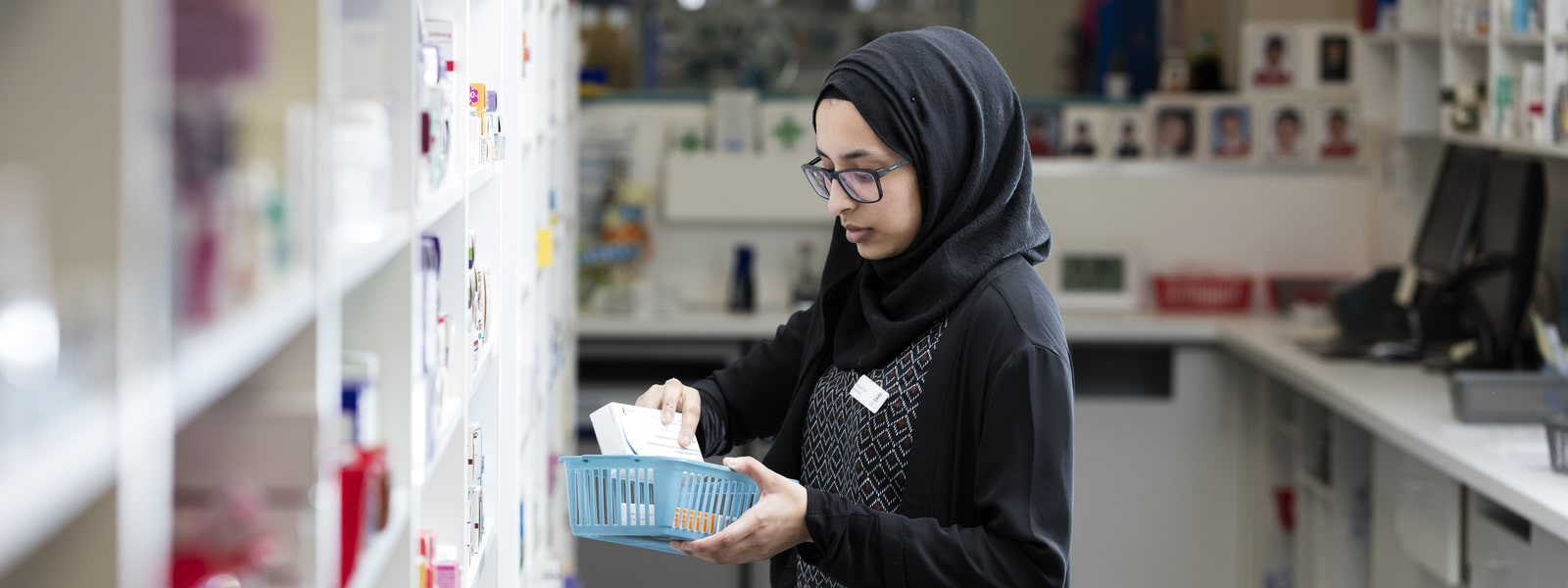 A student taking medicine from a shelf