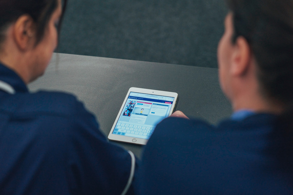 Two students looking at an iPad