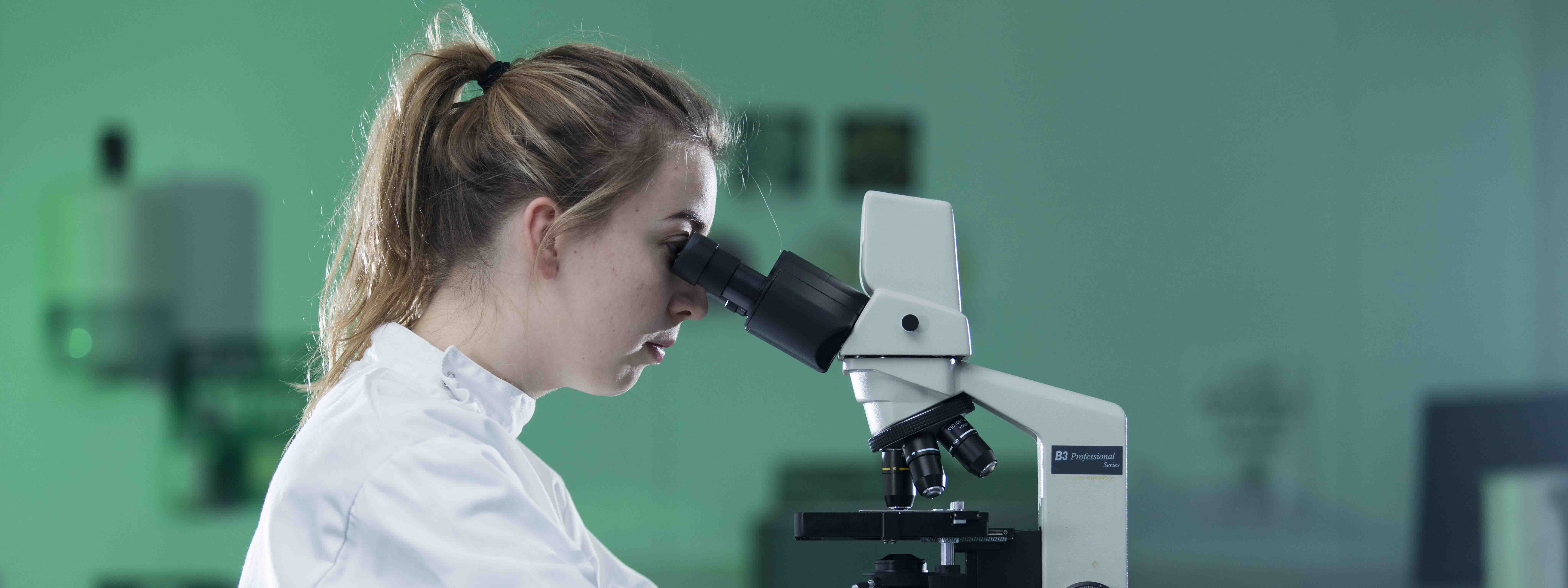 A student using a microscope