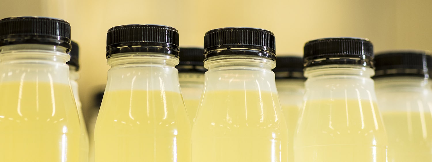 A row of filled bottles of liquid