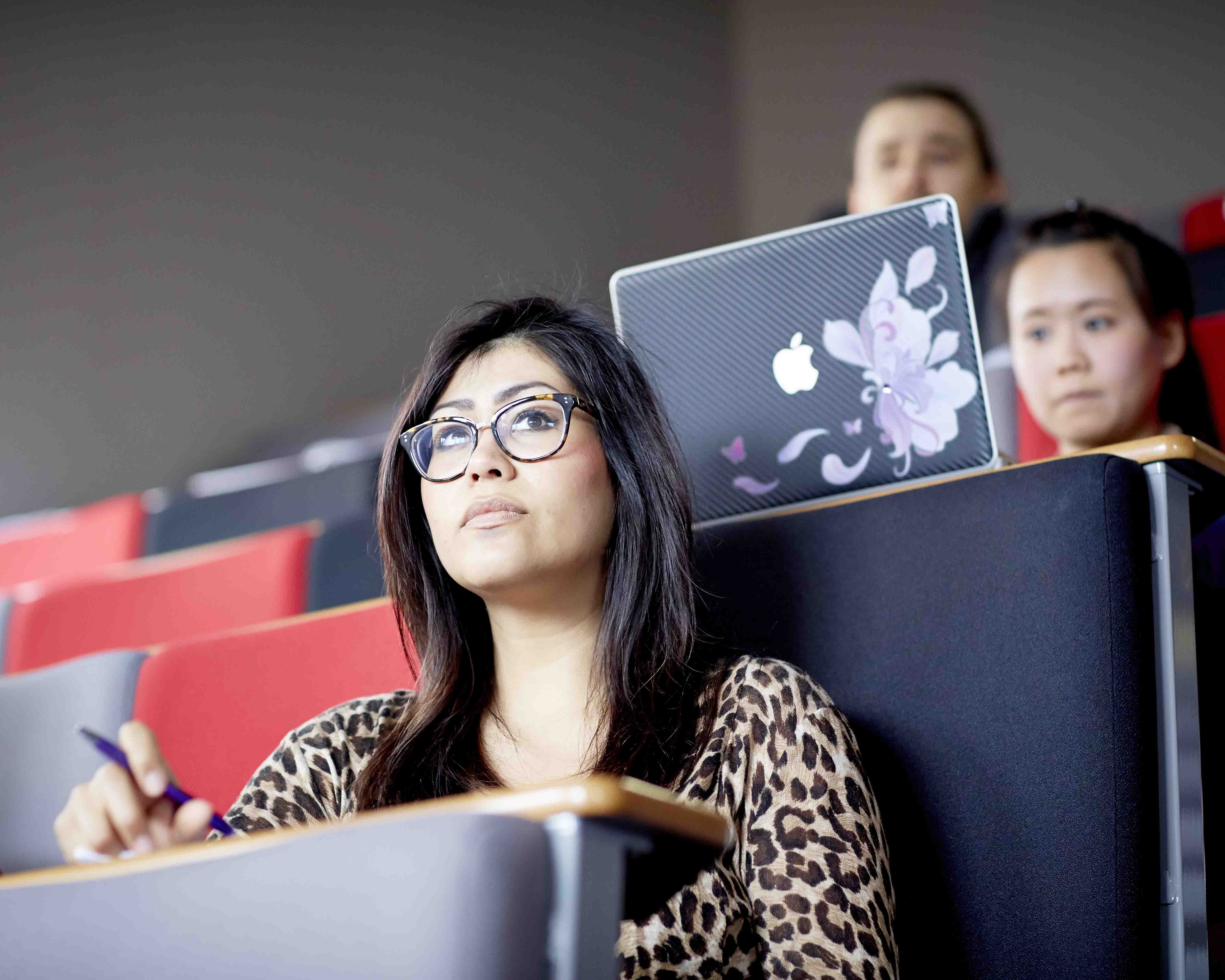 Three students in a lecture theatre