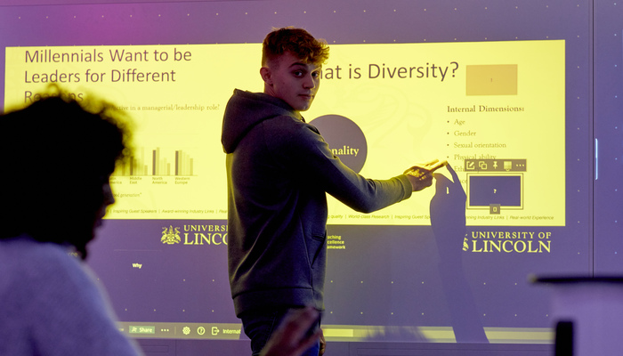 Student using an interactive board in a classroom