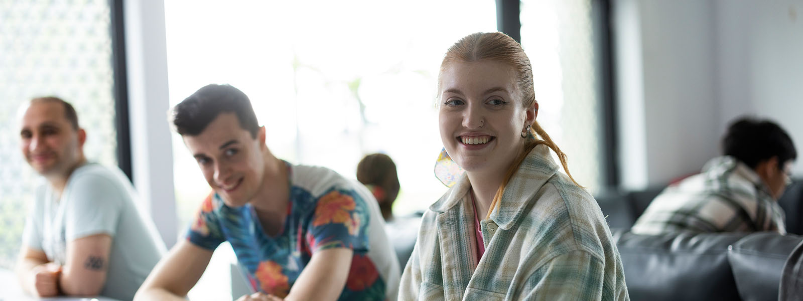 Two students sat at a table smiling